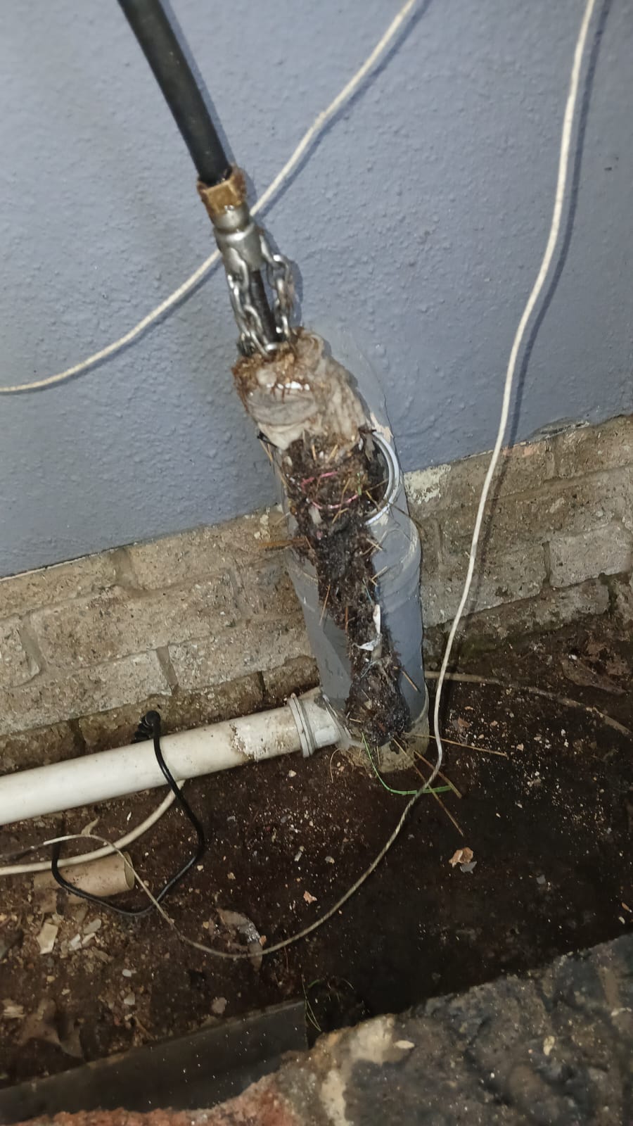 High-pressure water jetting cutting through root blockage in Midrand drain